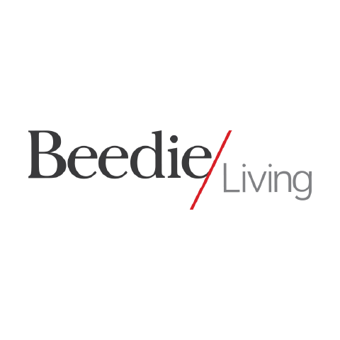 The word "Beedie" is in black, "Living" is in grey, and there's a red diagonal slash between them.