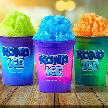 Three colorful cups of shaved Kona ice are placed on a rustic wooden table.