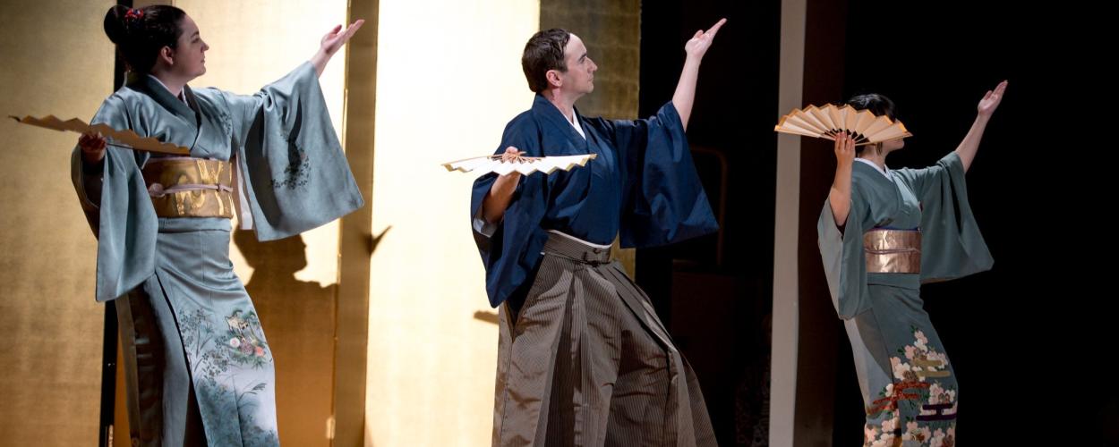 A group of individuals in traditional Japanese clothing performing a dance for the Tomoe Kai event.