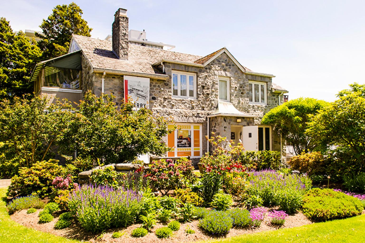The front of the Gertrude Lawson building, including a large garden.