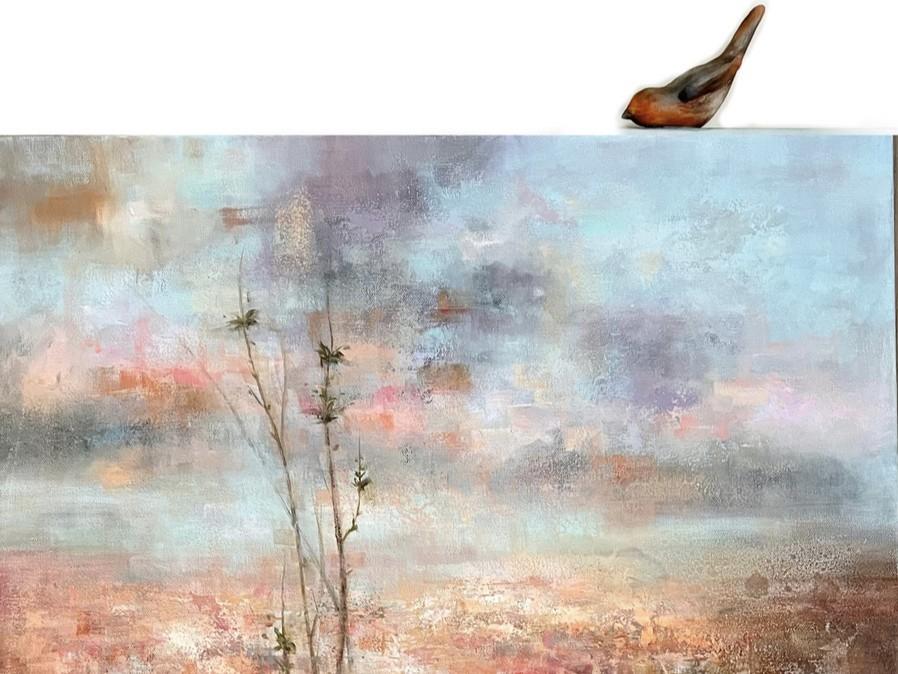 The image is a horizontal, landscape-oriented painting with a textured, impressionistic style. The painting depicts a soft, ethereal sky over a muted landscape. The sky occupies the upper two-thirds of the canvas and is rendered in a blend of pale blues, soft grays, and hints of lavender and pink, suggesting a diffused light, perhaps dawn or dusk. Streaks of warmer colors, like pale orange and muted peach, are visible through the clouds, adding depth and warmth. The texture of the paint is evident, with vis
