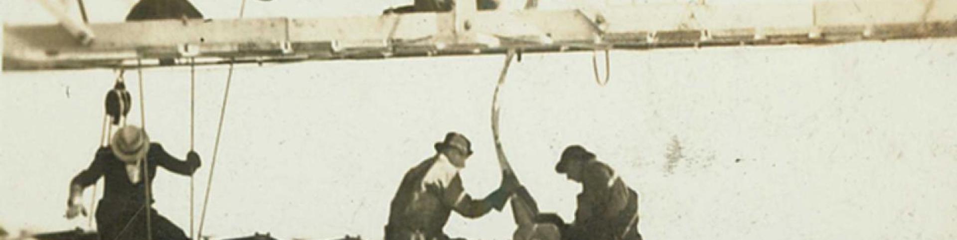 A grainy black and white photo of men working construction.