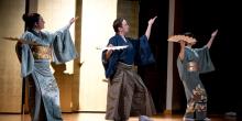 A group of individuals in traditional Japanese clothing performing a dance for the Tomoe Kai event.
