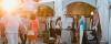 A group of shoppers navigating through a busy market, engaging with vendors and exploring various products.